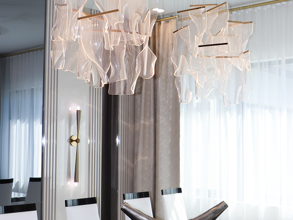 Contemporary sculptural chandelier above the formal dining room designed as a statement lighting feature in Flaava House.