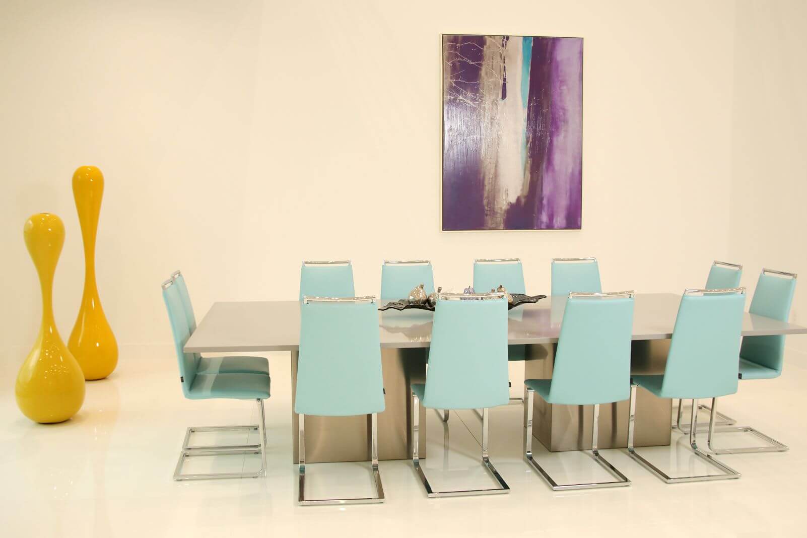 Contemporary dining room with designer lighting, custom furnishings, and modern artwork at Canvas Sur in Windermere, Florida.