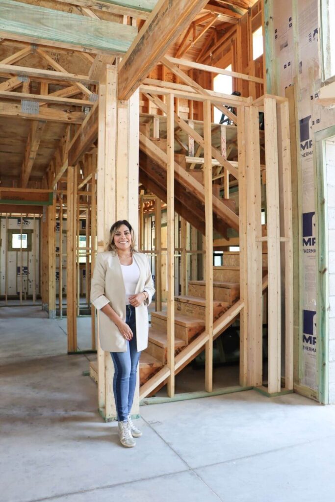 Zamira Ariza standing inside the framed entrance hall of Flaava House during construction in Lady Lake, Florida.