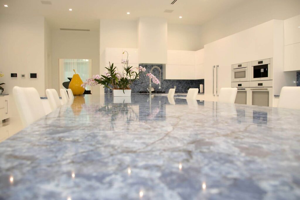 Close-up of the blue quartzite waterfall island designed for entertaining and family gatherings.