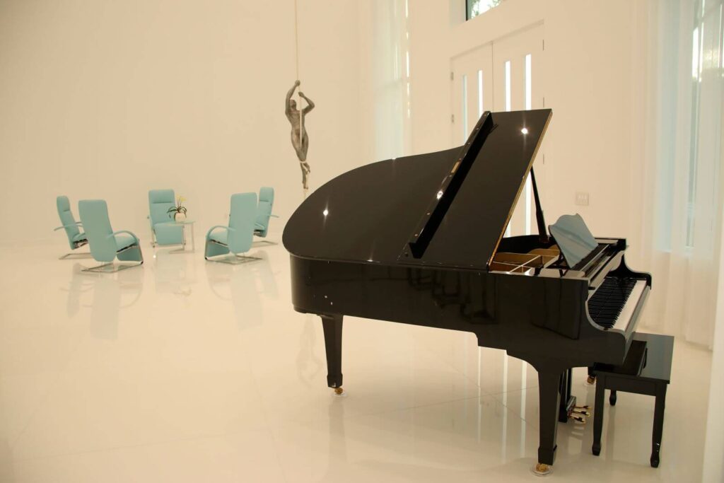 Grand piano showcased within the open-concept great room of Canvas Sur overlooking the lake.