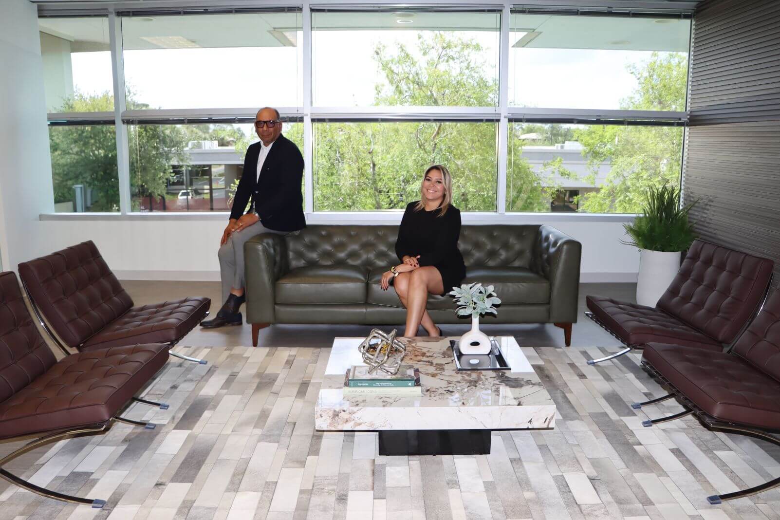 Completed luxury corporate reception designed by Zamira Ariza Interiors featuring premium finishes, elegant furnishings, and integrated branding.